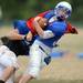 Lincoln football players run a play during the first day of pads at the school on Thursday. Melanie Maxwell I AnnArbor.com